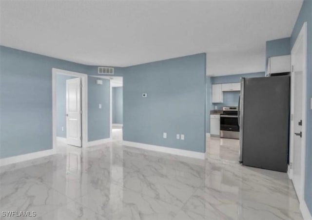 empty room with marble finish floor, baseboards, and visible vents