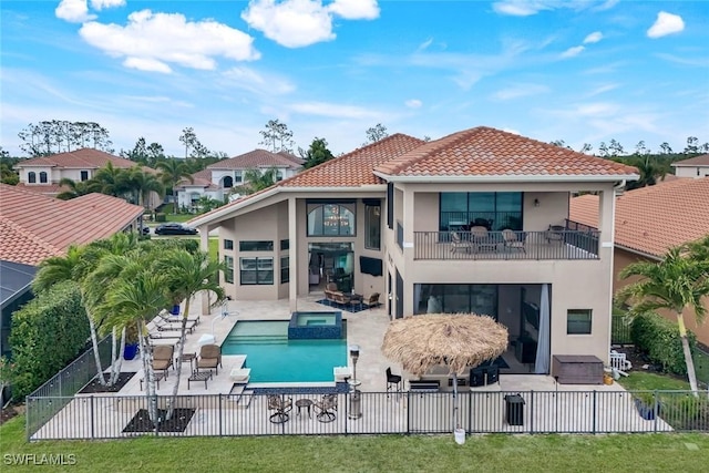2927 Cinnamon Bay Cir, Naples, FL 34119 - rear view of property with stucco siding, a fenced backyard, a balcony, a patio, and a pool with connected hot tub
