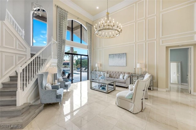 2927 Cinnamon Bay Cir, Naples, FL 34119 - living area featuring a towering ceiling, a decorative wall, a chandelier, stairway, and light marble finish flooring
