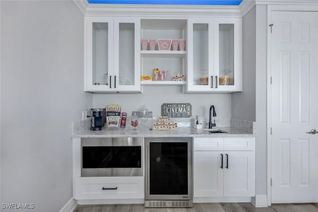 2927 Cinnamon Bay Cir, Naples, FL 34119 - indoor wet bar with beverage cooler, light wood-style flooring, baseboards, and built in microwave