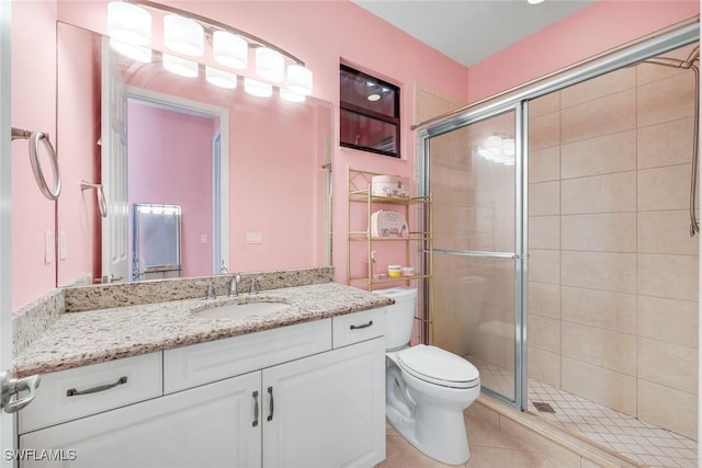 2927 Cinnamon Bay Cir, Naples, FL 34119 - bathroom with toilet, a shower stall, vanity, and tile patterned floors