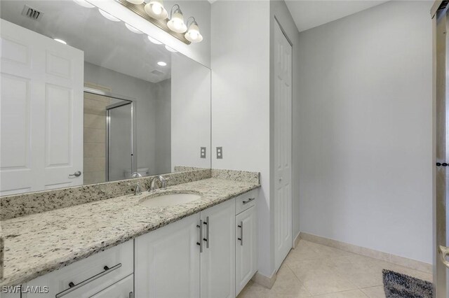 2927 Cinnamon Bay Cir, Naples, FL 34119 - bathroom with tile patterned flooring, a shower stall, vanity, baseboards, and toilet