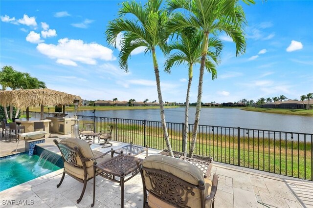 2927 Cinnamon Bay Cir, Naples, FL 34119 - view of swimming pool featuring exterior kitchen, a patio, and a water view