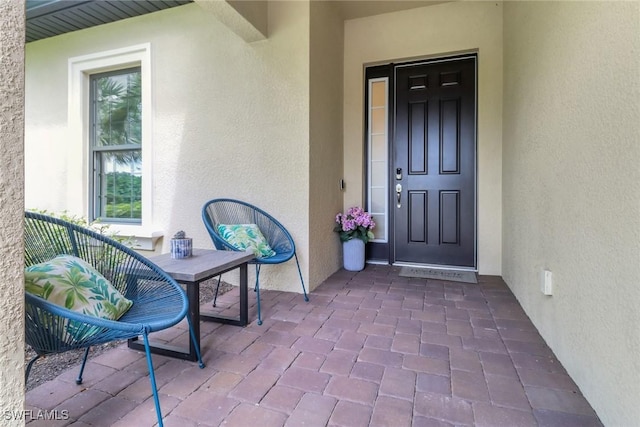 view of exterior entry featuring stucco siding
