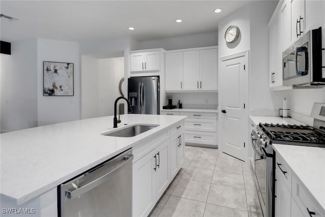 kitchen with appliances with stainless steel finishes, a sink, light countertops, recessed lighting, and visible vents