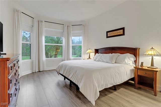 bedroom with baseboards and light wood-style flooring