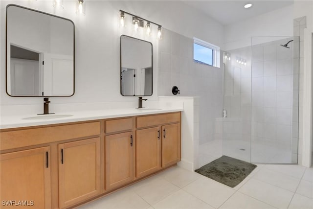 full bathroom with double vanity, walk in shower, and a sink