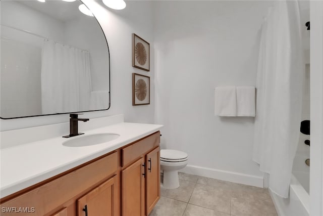 bathroom featuring vanity, tile patterned floors, and toilet