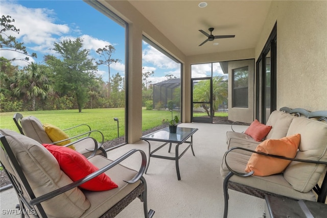 sunroom with a ceiling fan and an outdoor hangout area