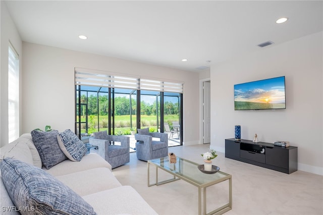 living room with baseboards, visible vents, a wealth of natural light, and recessed lighting