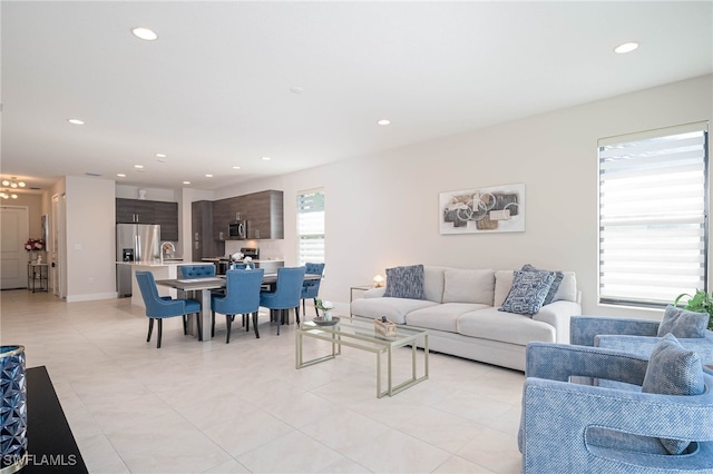 living area featuring a chandelier, recessed lighting, and light tile patterned floors