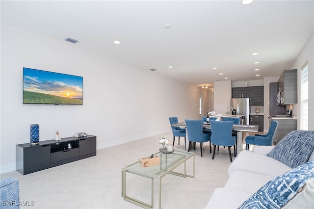 living area featuring visible vents and recessed lighting