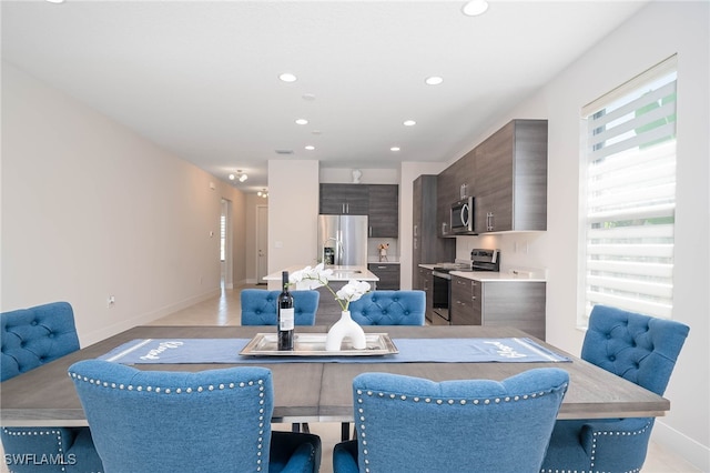 dining room with recessed lighting and baseboards