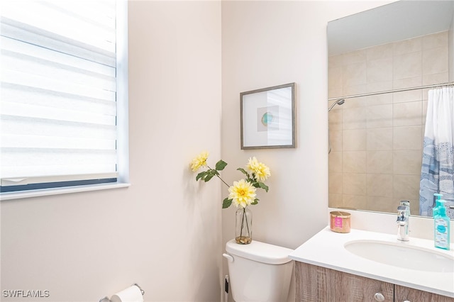 full bathroom with vanity, toilet, and curtained shower