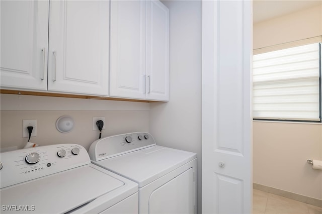 laundry room featuring light tile patterned flooring, cabinet space, independent washer and dryer, and baseboards
