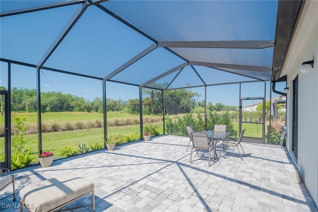 view of patio / terrace with glass enclosure and outdoor dining area