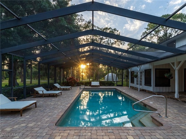 outdoor pool featuring a patio area and glass enclosure