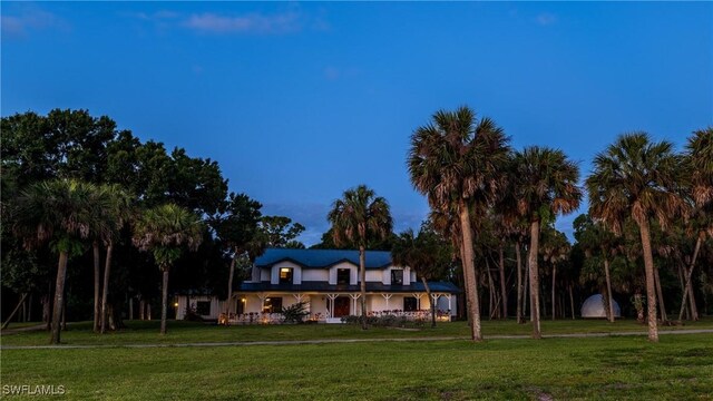cape cod house with a front lawn