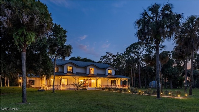back of property featuring a lawn