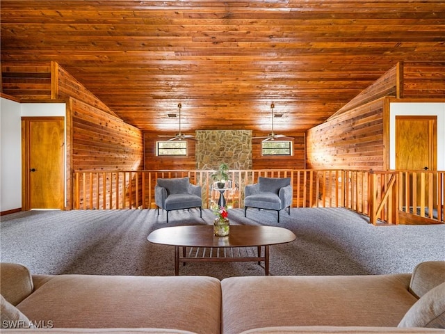 carpeted living area featuring lofted ceiling, wooden ceiling, and wooden walls