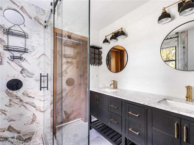 full bathroom with a sink, a shower stall, and double vanity