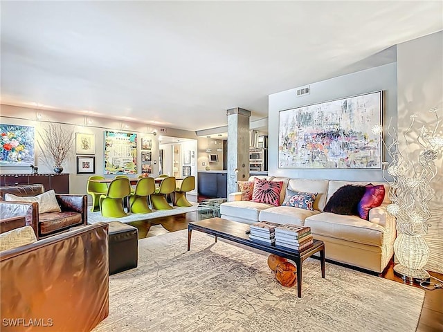 3399 Gulf Shore Blvd N Unit 605, Naples, FL 34103 - living room featuring visible vents and wood finished floors