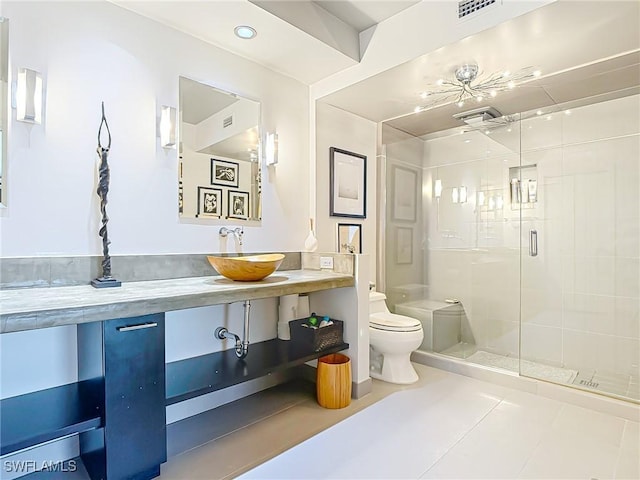 3399 Gulf Shore Blvd N Unit 605, Naples, FL 34103 - bathroom with tile patterned floors, a shower stall, toilet, vanity, and visible vents