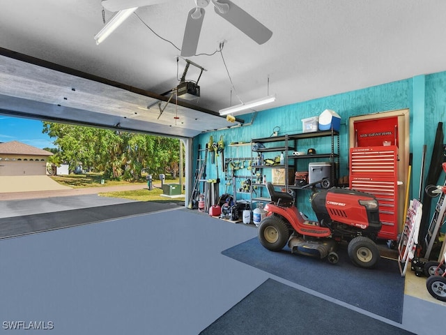 1210 Marlow St, Port Charlotte, FL 33952 - garage with a ceiling fan and a garage door opener