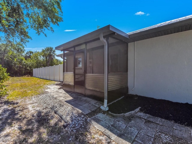 1210 Marlow St, Port Charlotte, FL 33952 - view of property exterior with fence and a sunroom