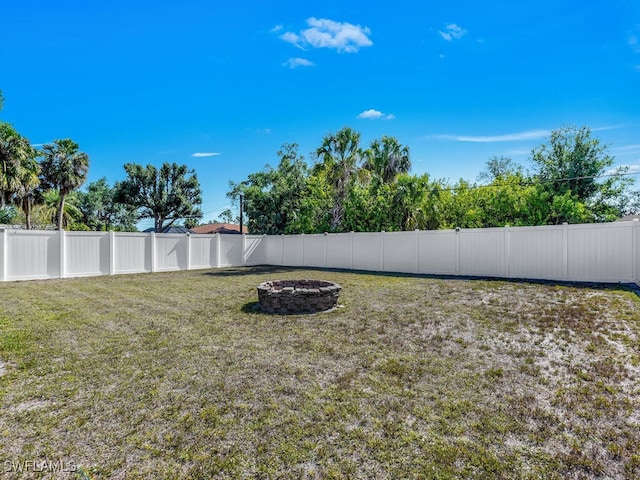 1210 Marlow St, Port Charlotte, FL 33952 - view of yard with a fenced backyard and an outdoor fire pit