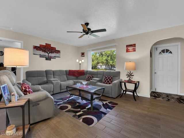 1210 Marlow St, Port Charlotte, FL 33952 - living area with arched walkways, a ceiling fan, wood finished floors, and baseboards