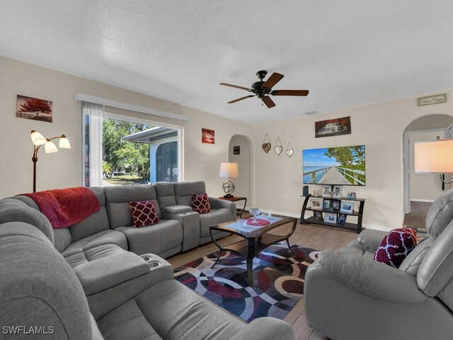 1210 Marlow St, Port Charlotte, FL 33952 - living area with baseboards, wood finished floors, arched walkways, and ceiling fan