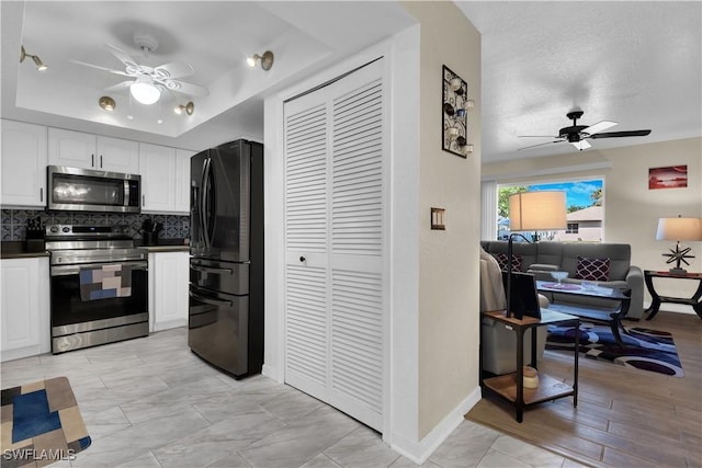 1210 Marlow St, Port Charlotte, FL 33952 - kitchen with dark countertops, backsplash, a ceiling fan, and stainless steel appliances