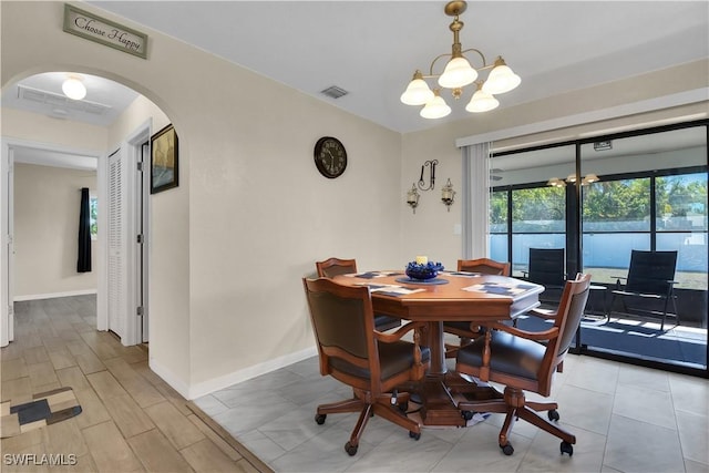 1210 Marlow St, Port Charlotte, FL 33952 - dining space with baseboards, visible vents, arched walkways, and a chandelier
