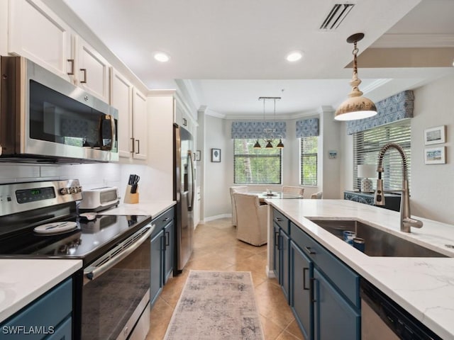 9834 Giaveno Cir Unit 1717, Naples, FL 34113 - kitchen featuring blue cabinets, a sink, white cabinets, ornamental molding, and stainless steel appliances