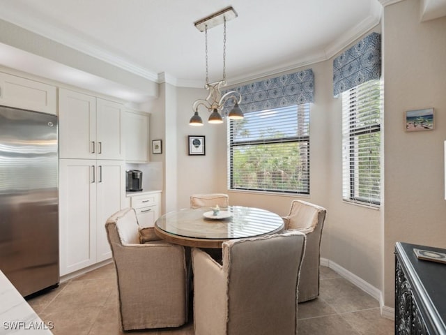 9834 Giaveno Cir Unit 1717, Naples, FL 34113 - dining room with baseboards, an inviting chandelier, ornamental molding, and light tile patterned floors