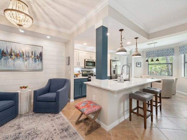 9834 Giaveno Cir Unit 1717, Naples, FL 34113 - kitchen with appliances with stainless steel finishes, ornamental molding, a breakfast bar, and open floor plan
