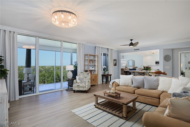 4761 W Bay Blvd Unit 303, Estero, FL 33928 - living area with a chandelier, crown molding, light wood finished floors, and ceiling fan