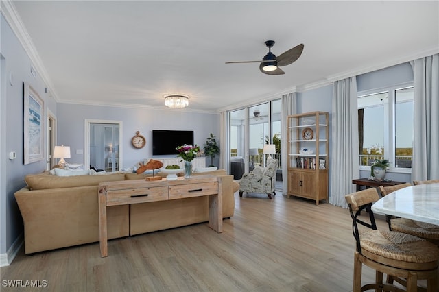 4761 W Bay Blvd Unit 303, Estero, FL 33928 - living room featuring a ceiling fan, light wood finished floors, ornamental molding, and baseboards