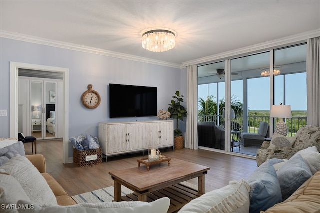 4761 W Bay Blvd Unit 303, Estero, FL 33928 - living area with a chandelier, crown molding, and wood finished floors
