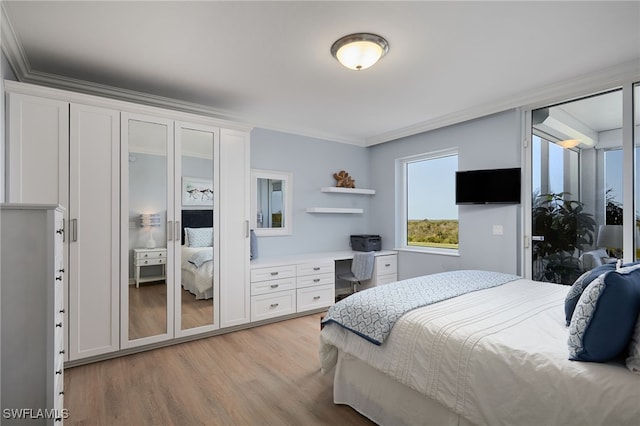 4761 W Bay Blvd Unit 303, Estero, FL 33928 - bedroom featuring light wood-style floors, ornamental molding, and an office area