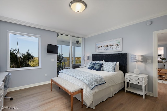 4761 W Bay Blvd Unit 303, Estero, FL 33928 - bedroom with crown molding, wood finished floors, and baseboards