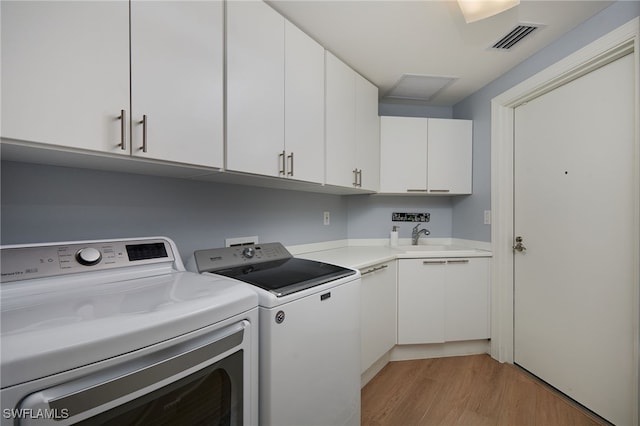 4761 W Bay Blvd Unit 303, Estero, FL 33928 - laundry room featuring washing machine and clothes dryer, cabinet space, and light wood-type flooring