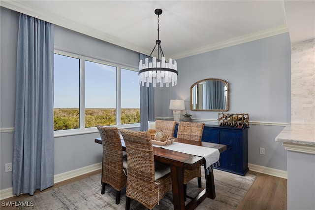 4761 W Bay Blvd Unit 303, Estero, FL 33928 - dining room featuring a chandelier, wood finished floors, ornamental molding, and baseboards