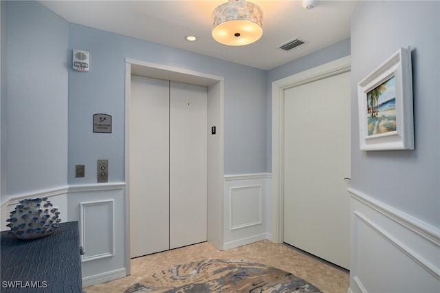 4761 W Bay Blvd Unit 303, Estero, FL 33928 - entrance foyer featuring elevator, a wainscoted wall, a decorative wall, and recessed lighting