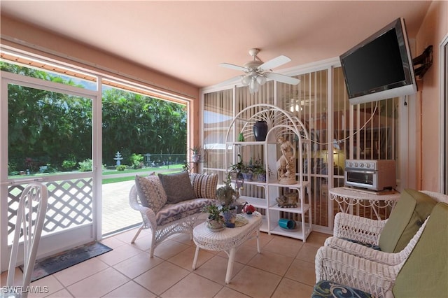 sunroom featuring a ceiling fan