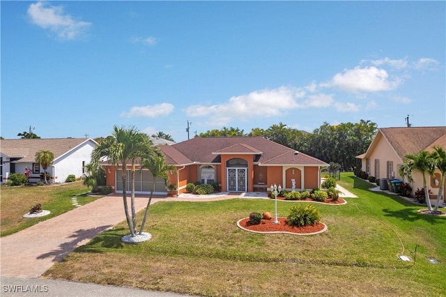 view of front of property featuring concrete driveway, an attached garage, a front yard, and stucco siding