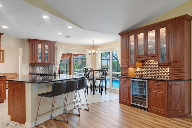 212 SE 30th Ter, Cape Coral, FL 33904 - bar featuring beverage cooler, a sink, a chandelier, tasteful backsplash, and recessed lighting