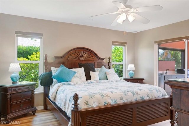 212 SE 30th Ter, Cape Coral, FL 33904 - bedroom featuring light wood finished floors, access to exterior, ceiling fan, and baseboards