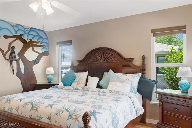 212 SE 30th Ter, Cape Coral, FL 33904 - bedroom with wood finished floors and ceiling fan